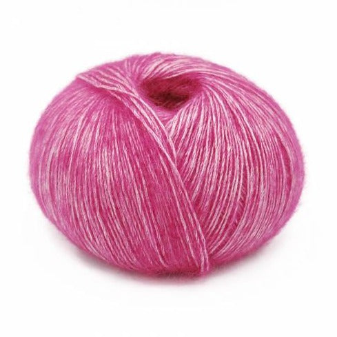 Wound ball of Mirasol Inka yarn in a slightly shiny tourmaline/pink color.
