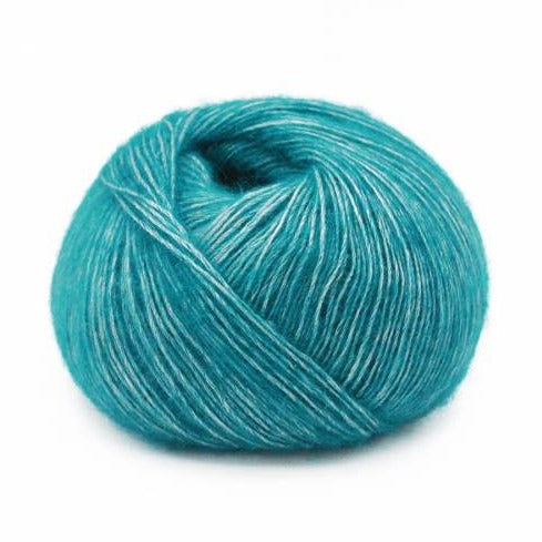 Wound ball of Mirasol Inka yarn in a slightly shiny malachite/teal color.