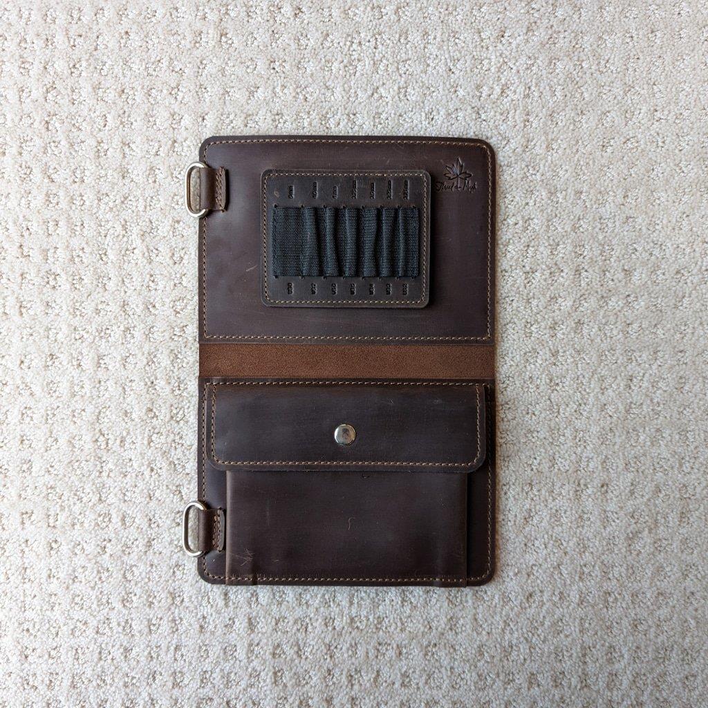Chocolate colored leather knitting needle case open showing large slots and notions pocket 