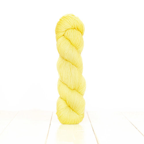 Harvest Fingering dyed light, bright yellow with Citrus.