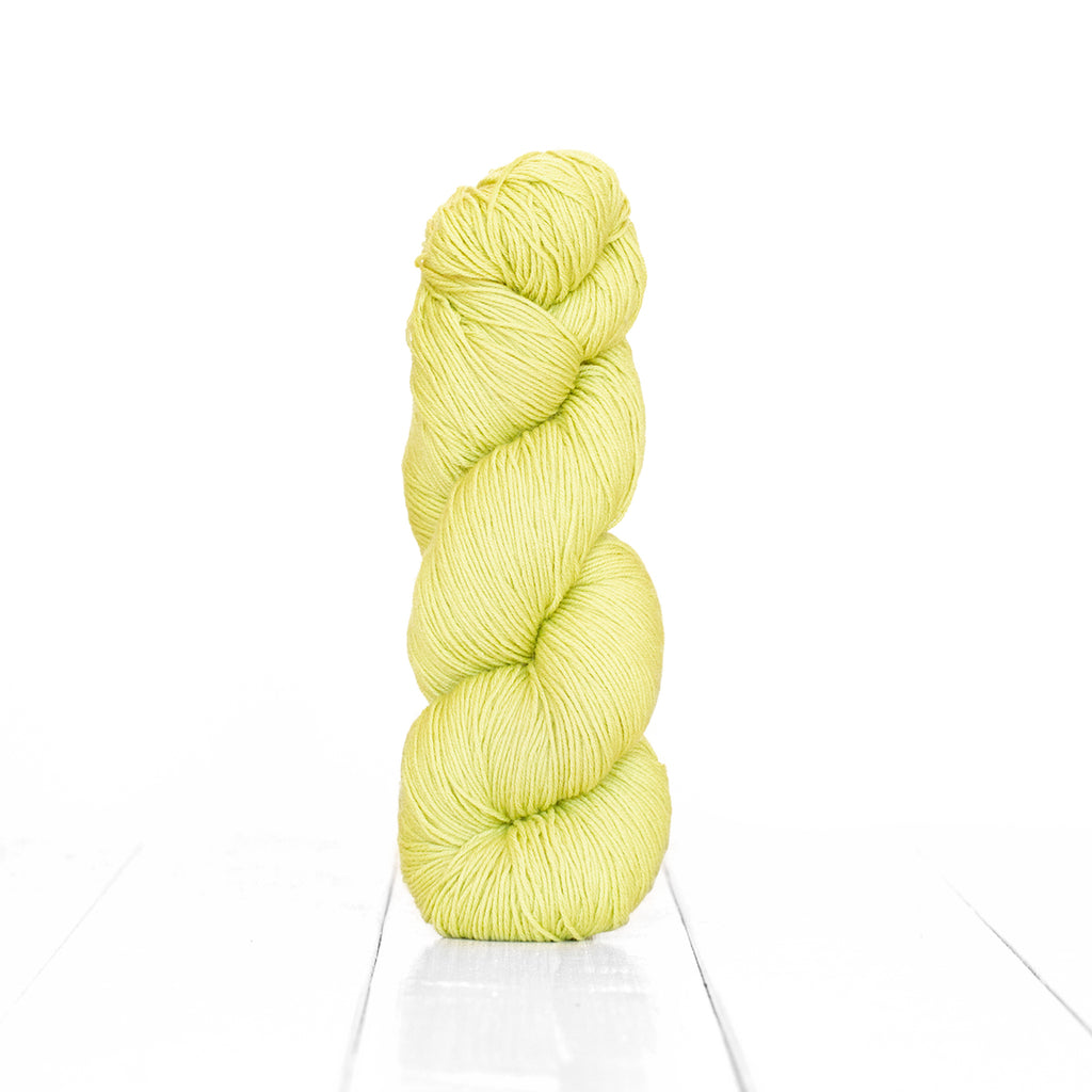 Color Pistachio, hand-dyed skein of yarn, light yellow green color produced from natural pistachios.