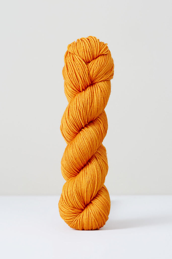 Color Orange, hand-dyed skein of yarn, in a bright orange color naturally dyed with oranges.