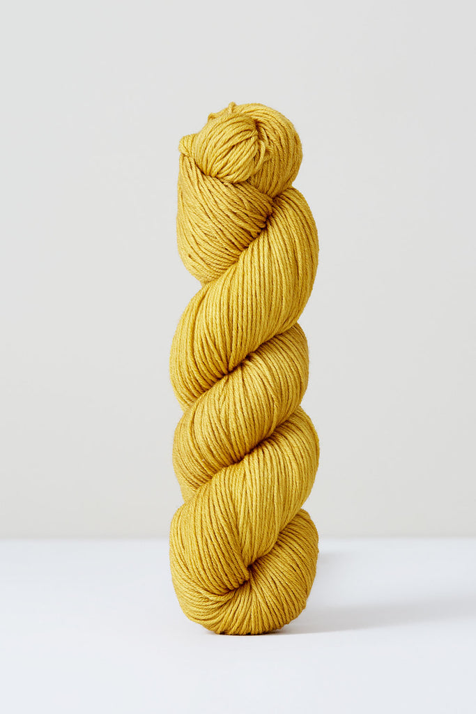 Color Pomegranate, hand-dyed skein of yarn, in a mustard yellow naturally dyed with pomegranates.