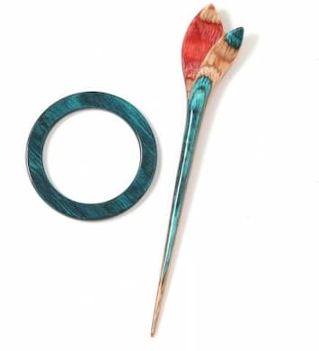 Multi colored wooden ring and stick pin with lily flower on top of stick pin.