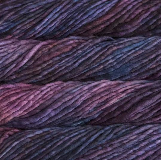 Color: Abril 853. A medium purple, purple and mauve variegated variant of Malabrigo Rasta yarn. 