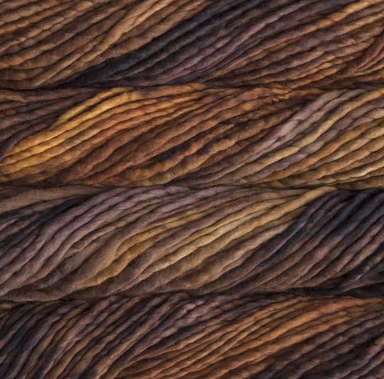 Color: Coronilla 868. A gold and brown variegated variant of Malabrigo Rasta yarn. 