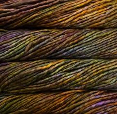 Color: Piedras 862. A brown, gold, and purple variegated variant of Malabrigo Rasta yarn. 
