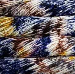 Color: Pintada Mejillon 167. An ochre yellow, blue, brown and white variant of Malabrigo Rasta yarn.