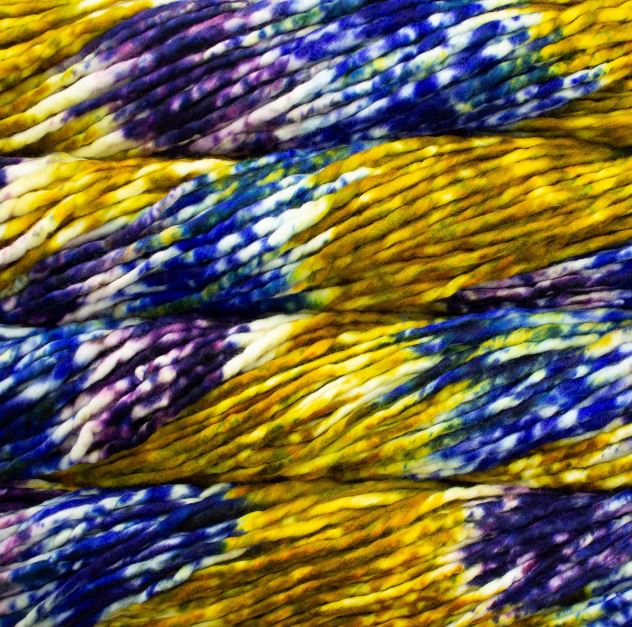 Color: Pintada Pensamiento 170. An ochre yellow, purple, blue and white variant of Malabrigo Rasta