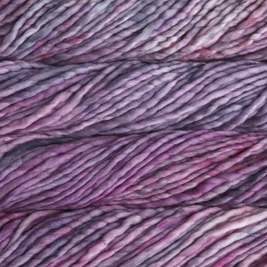 Color: Porrinho 864. A dusty pink and mauve variegated variant of Malabrigo Rasta yarn. 