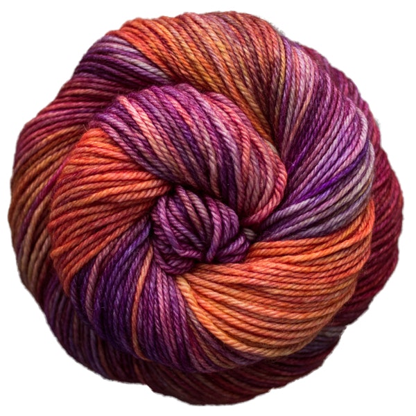 A skein of Caprino in the color Archangel 850, a variegated colorway of warm sunset colors.