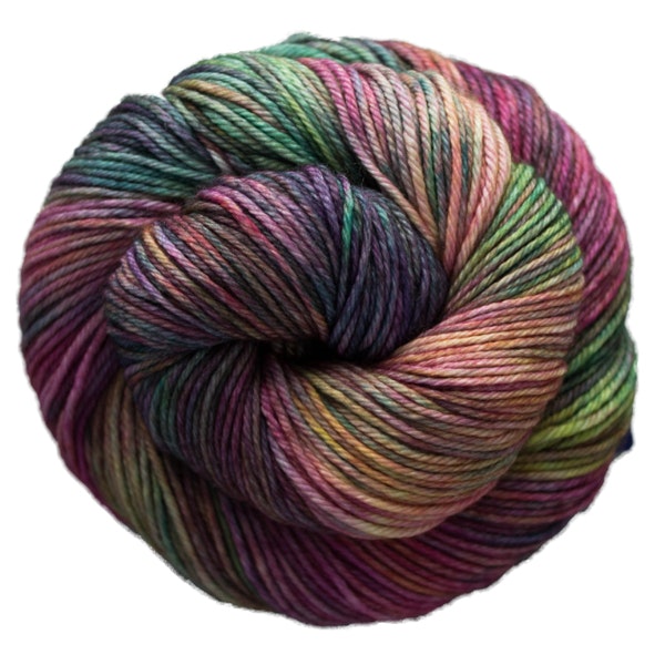 A skein of Caprino in the color Arco Iris 866, a variegated green, yellow, purple, & pink colorway.