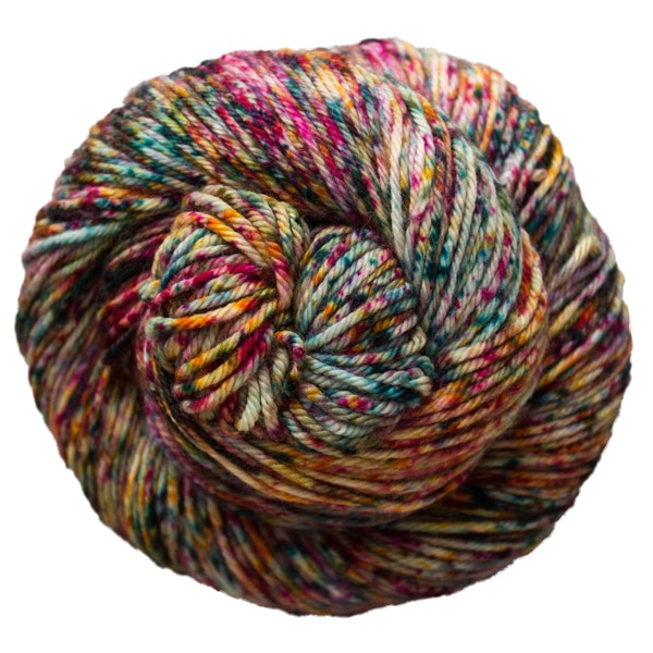 A skein of Caprino in the color Carnival 669, a speckled pink orange, teal, and purple colorway.
