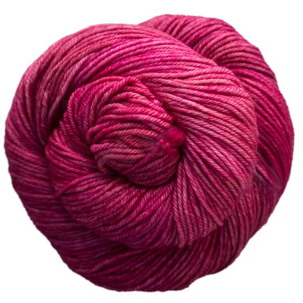 A skein of Caprino in the color English Rose 057, a tonal bright pink colorway.