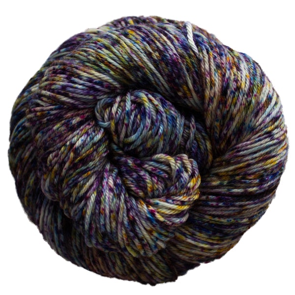 A skein of Caprino in the color Galaxy 717, a speckled purple, blue, and yellow colorway.