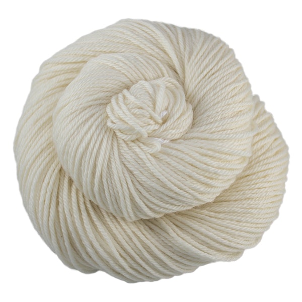 A skein of Caprino in the color Natural 063, a natural ercu off-white colorway.