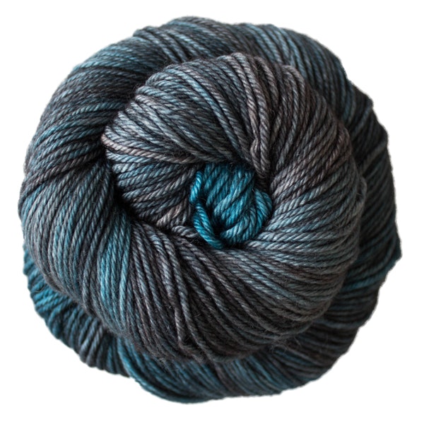A skein of Caprino in the color Persia 852, a variegated grey and blue colorway.