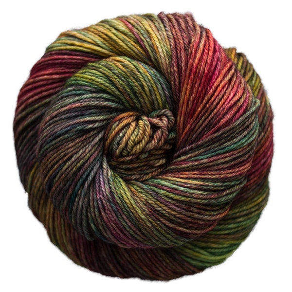 A skein of Caprino in the color Piedras 862, a variegated green, purple, orange, and pink colorway.