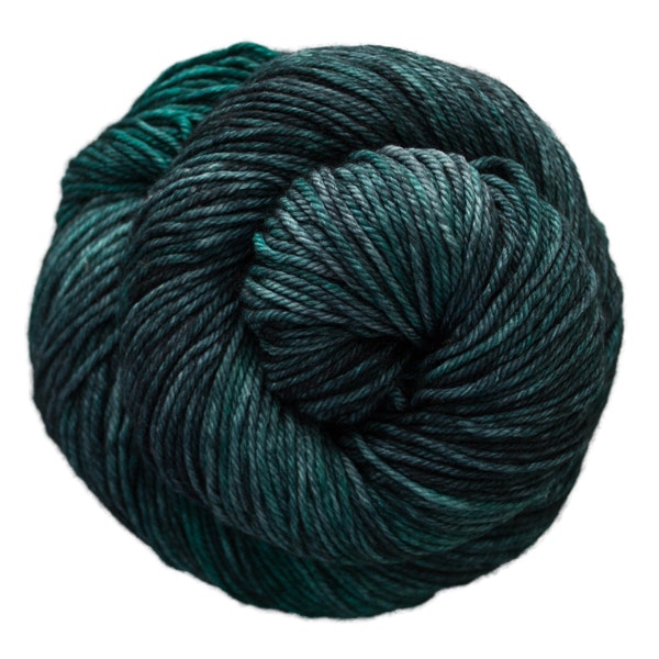 A skein of Caprino in the color Pines 213, a tonal dark green-blue colorway.