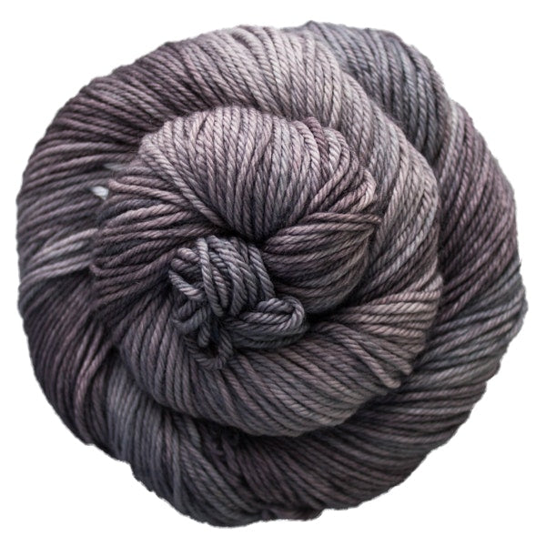 A skein of Caprino in the color Plomo 043, a tonal warm medium grey colorway.