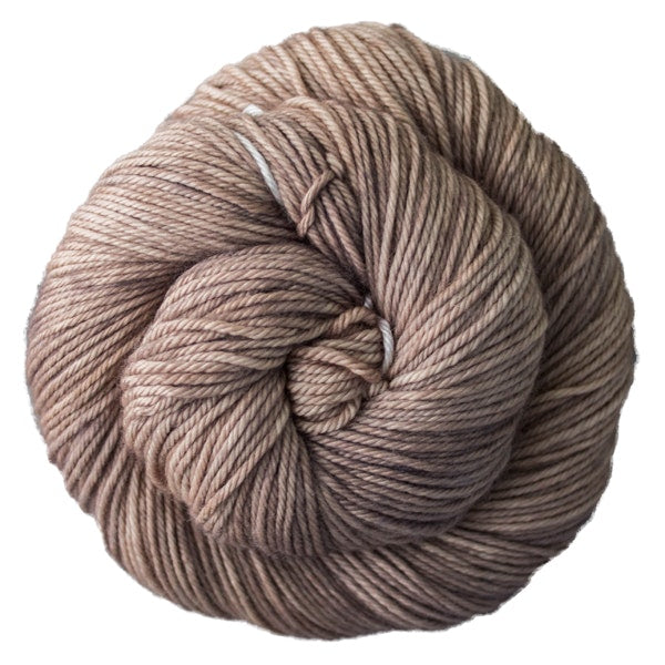A skein of Caprino in the color Sand Bank 131, a tonal tan colorway.