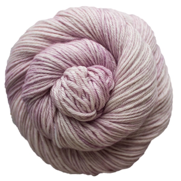 A skein of Caprino in the color Valentina 689, a tonal pale pink colorway.