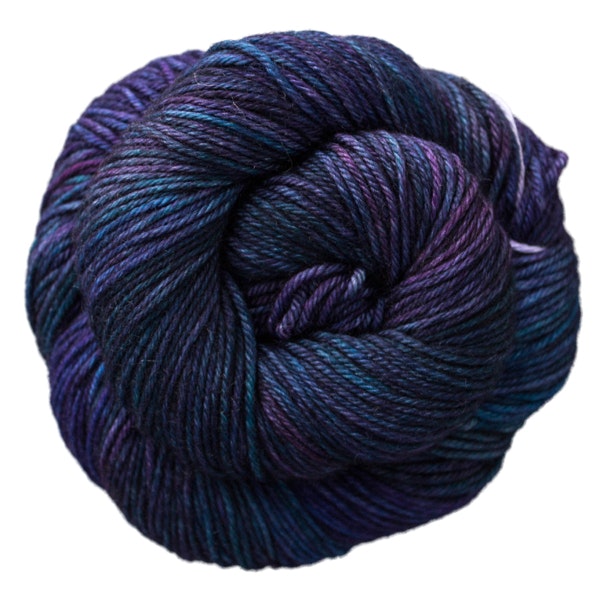 A skein of Caprino in the color Whale's Road 247, a blue and purple colorway.