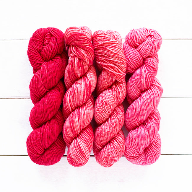 Color 801, a red 4 skein gradient dyed yarn kit fading from dark solid to speckled.