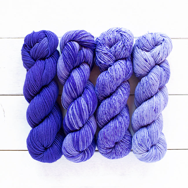 Color 808, a indigo 4 skein gradient dyed yarn kit fading from dark solid to speckled.