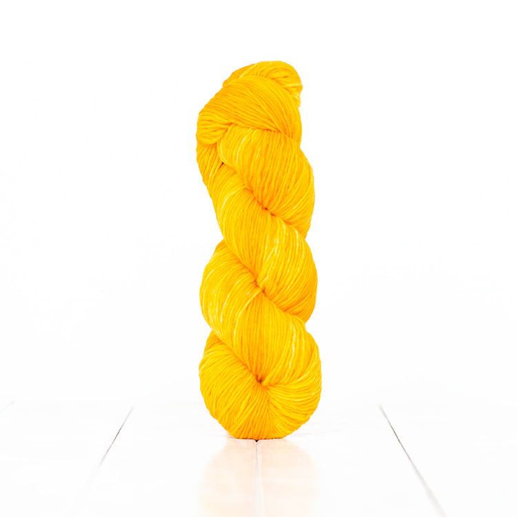 Color 6053, a variegated monochromatic skein of bright sunny yellow yarn.