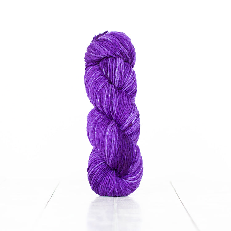 Color 6055, a variegated monochromatic skein of vibrant purple yarn.