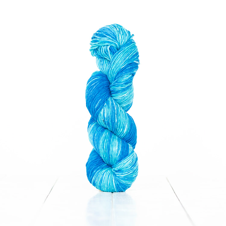 Color 6057, a variegated monochromatic skein of vibrant turquoise yarn.