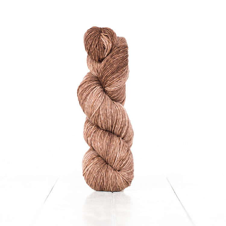 Color 6060, a variegated monochromatic skein of warm light brown yarn.