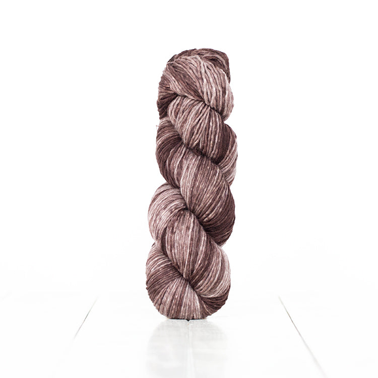 Color 6061, a variegated monochromatic skein of greyish brown yarn.