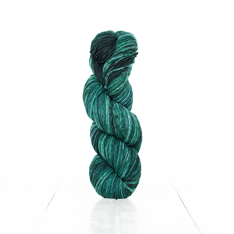 Color 6065, a variegated monochromatic skein of yarn in dark blue-green.