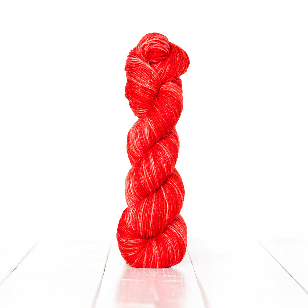 Color 3051, a variegated monochromatic skein of bright red yarn.