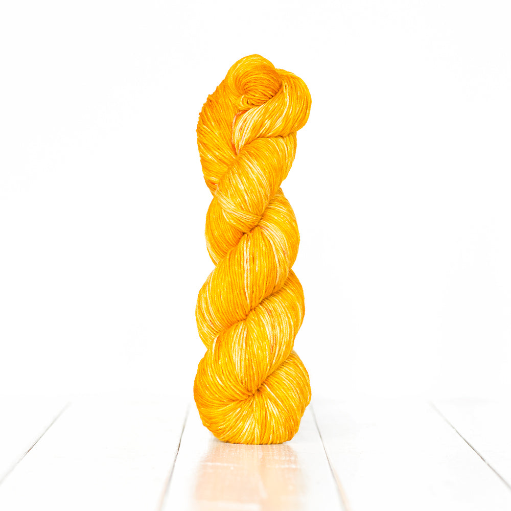 Color 3053, a variegated monochromatic skein of bright sunny yellow yarn.