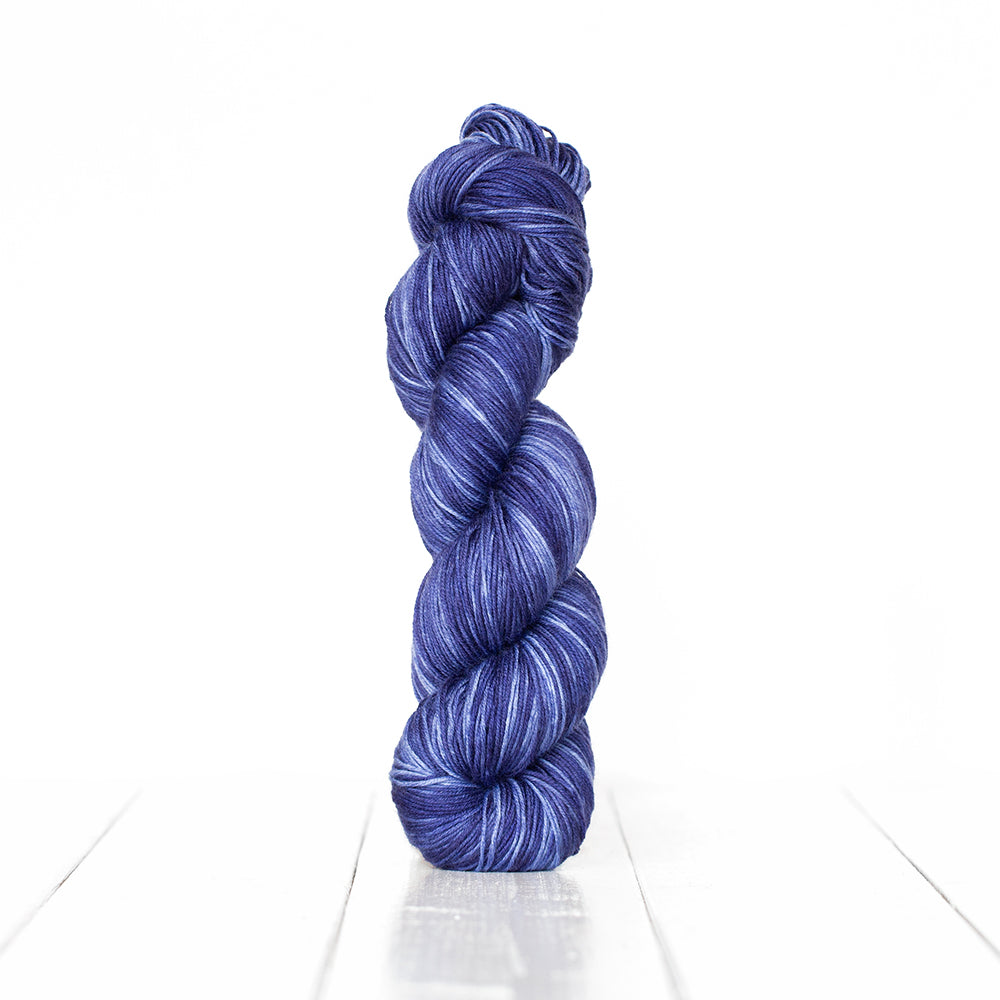 Color 3056, a variegated monochromatic skein of dark blue yarn.