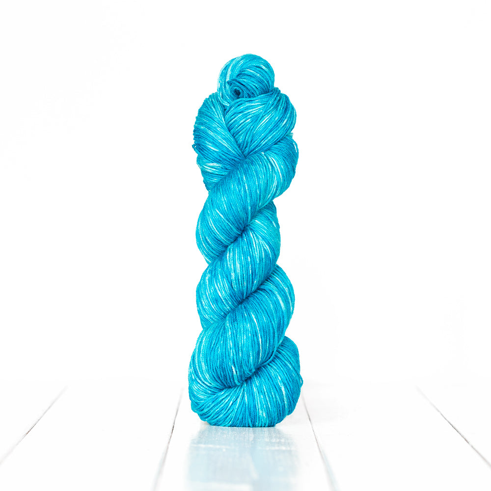 Color 3057, a variegated monochromatic skein of vibrant turquoise yarn.