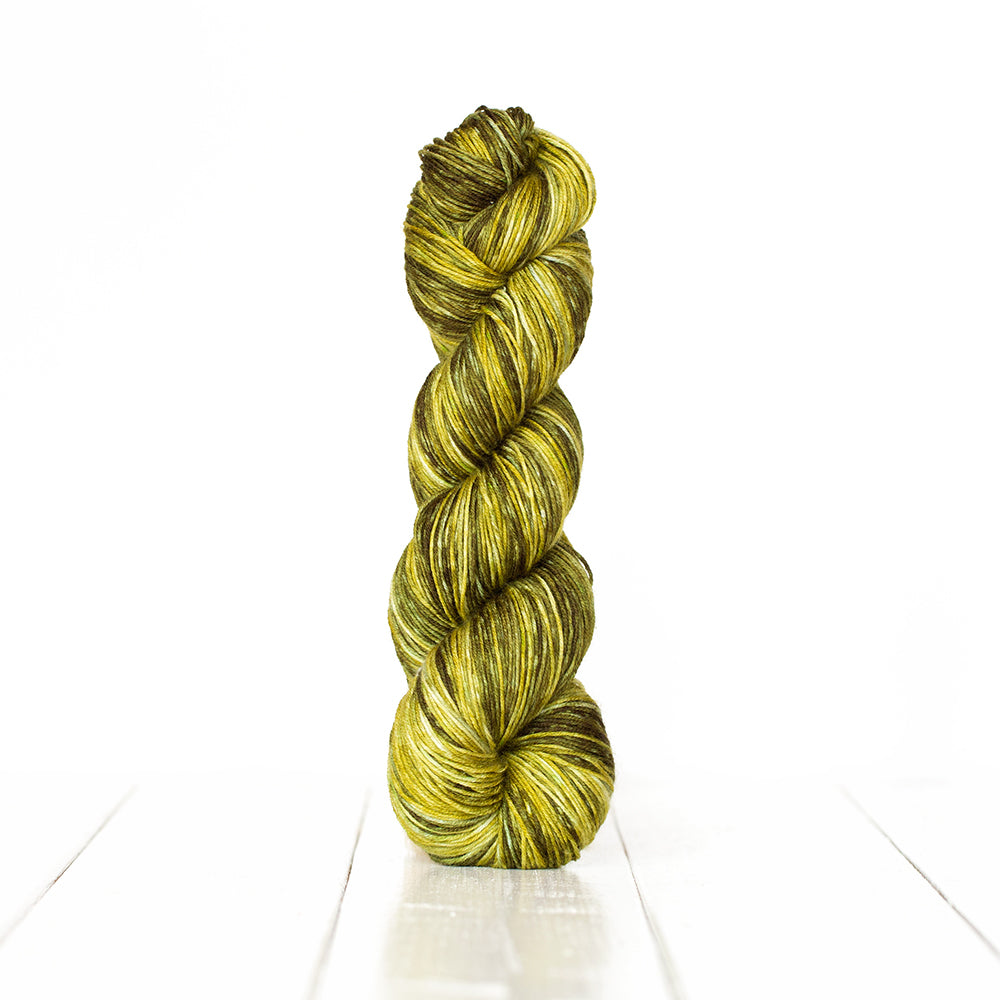 Color 3059, a variegated monochromatic skein of yellowish  green yarn.