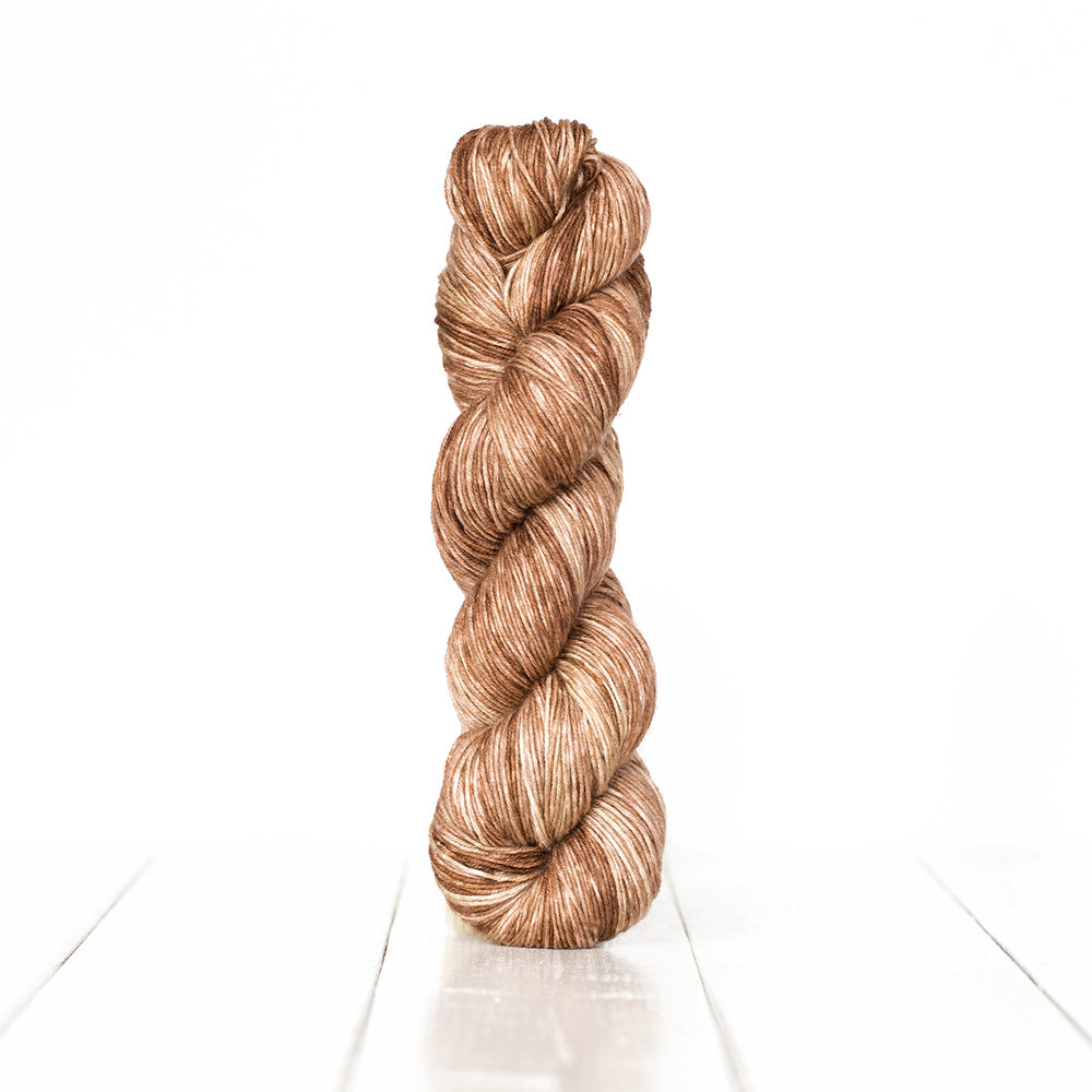 Color 3060, a variegated monochromatic skein of warm light brown yarn.