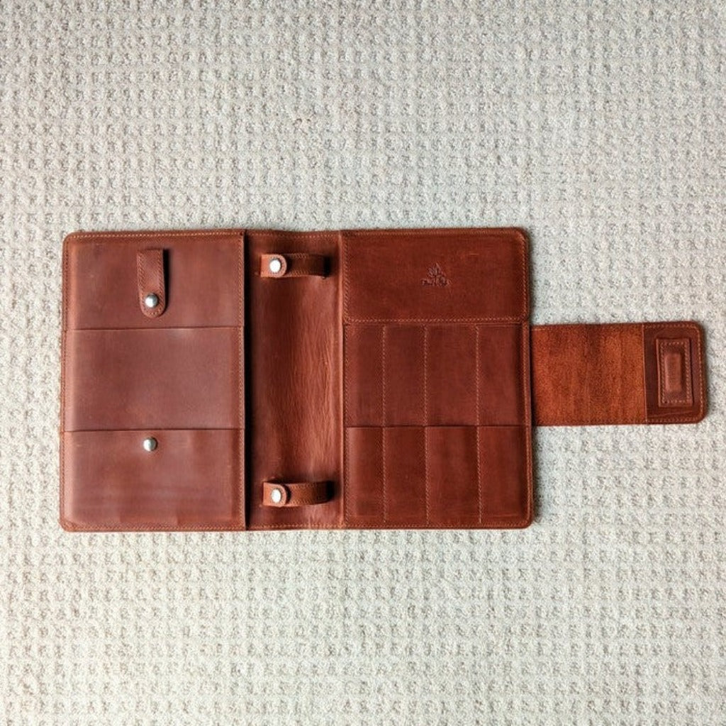 Thread and Maple Leather knitting needle binder in Whiskey open to reveal the pockets inside. 