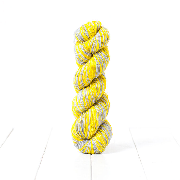 PAN21, a limited edition self striping yellow and grey fingering weight yarn inspired by Pantone's 2021 colors of the year.