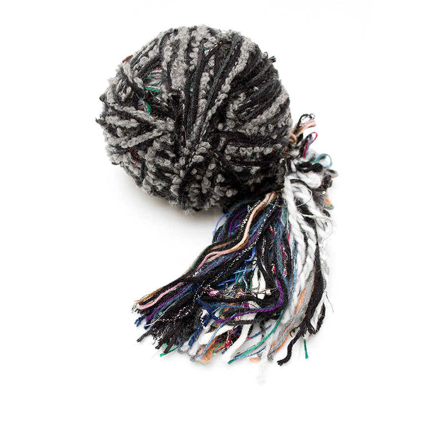 Color #6: a hand wound ball of yarn, mainly black and grey with some blue, purple, green, & white.