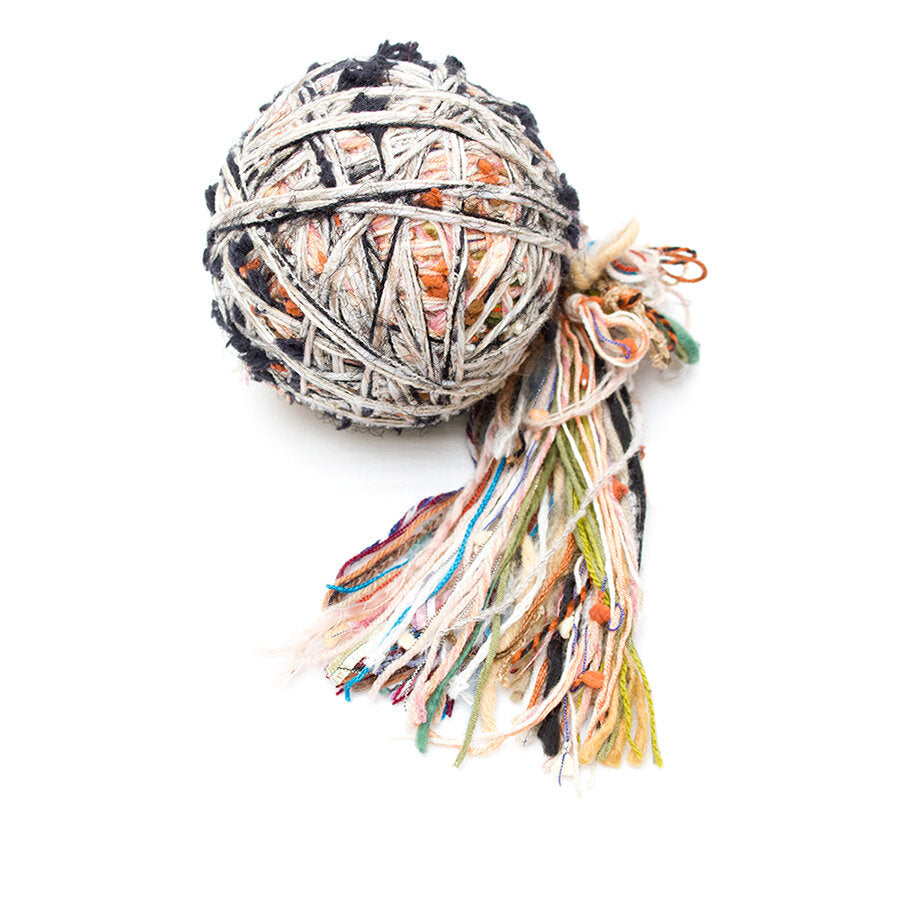 Color #7: a ball of yarn that is a light mix of white, orange, pink, yellow, green, & black.