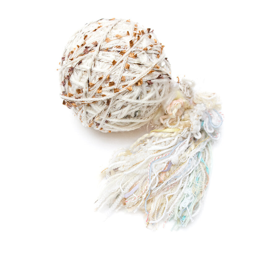 Color #10: a hand wound ball of yarn, mainly white, with a few soft pastels and some gold mixed in.