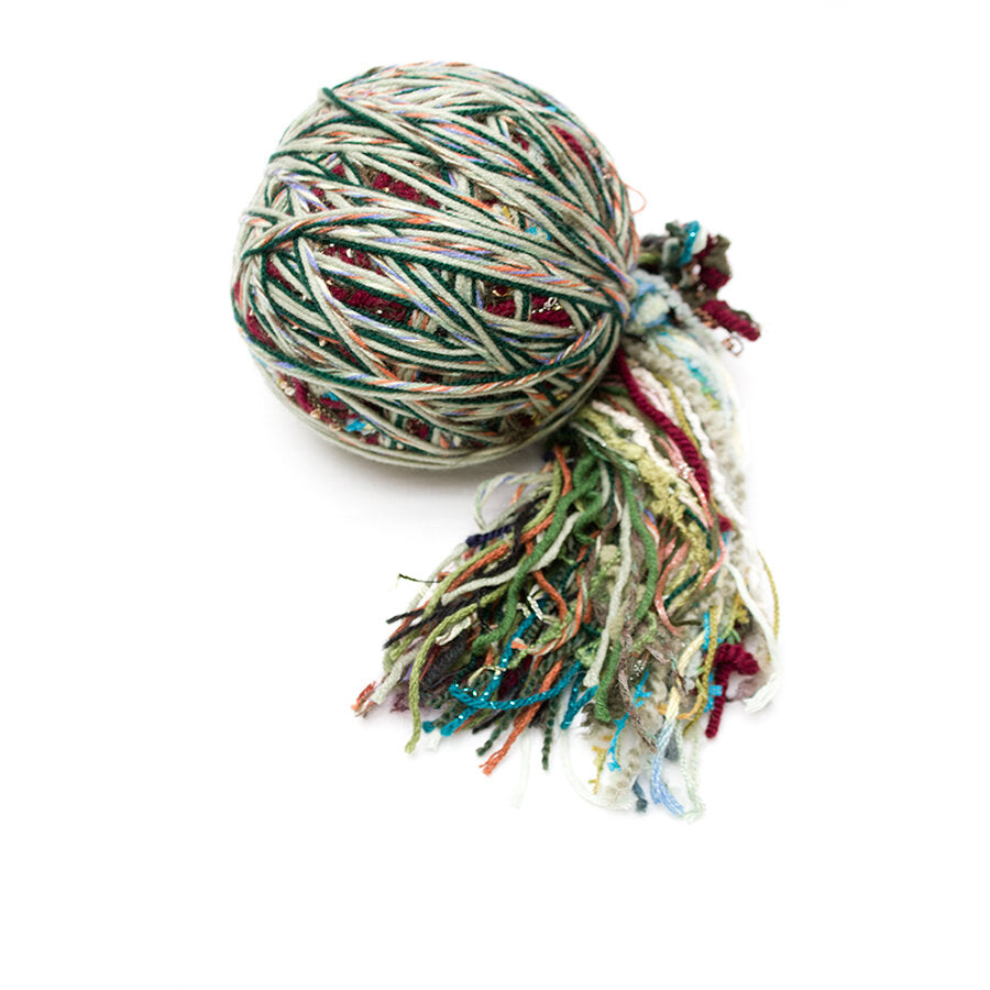 Color #12: a hand wound ball of yarn, mainly greens with some dark red, turquoise, & dull orange.