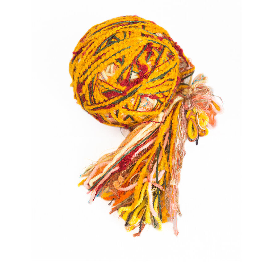 Color #15: a hand wound ball of yarn, a rich, saffron yellow with a little dark green and red.
