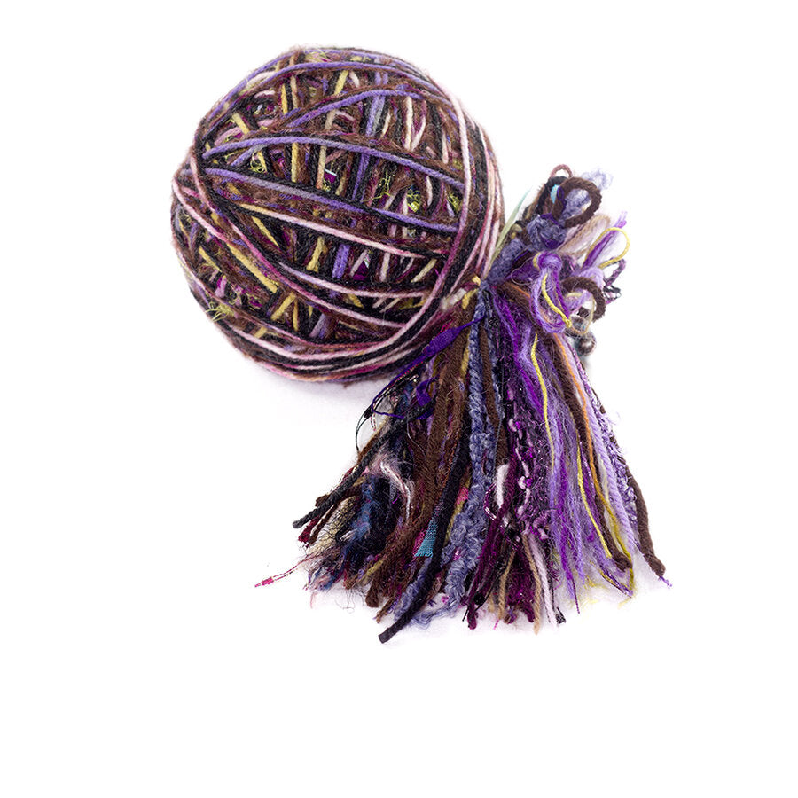 Color #23: a hand wound ball of yarn, mainly purple & brown, with some black, yellow, and pink.