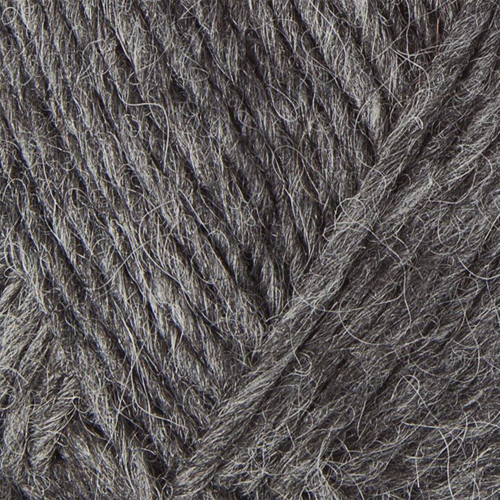 Dark Grey 0058, a dark heathered grey skein of Lopi's Álafosslopi, a bulky Icelandic wool yarn.